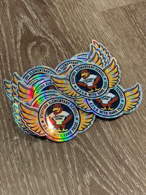 Holographic personalized die cut, round, and logo stickers by DC Print Haus displayed on a clean surface.